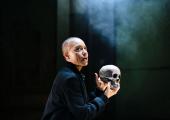 Hamlet (Cush Jumbo) contemplates mortality while holding Yorick's skull