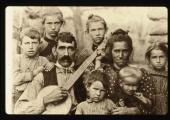 Banjo player and family, c. 1900