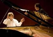Stefan Knüpfer (left) discusses the arcane mysteries of piano preparation with Pierre-Laurent Aimard