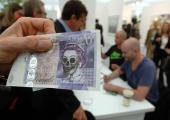 A defaced £20 note by Jake and Dinos Chapman: 'The cash may be flowing, but the cost is too high'