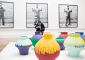 Ai Weiwei taking a photograph of his installation Coloured Vases, Royal Academy of Arts, 2015