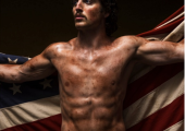 Benson Boone draped in an American flag and looking a bit oily