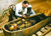 Howard Carter and assistant clean Tutankhamum's gold coffin