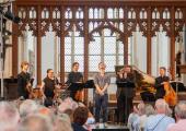 Tom Coult receives a big ovation for the world premiere of 'Black Shuck Lament', given by Allan Clayton and members of the Dunedin Consort in Blythburgh Church