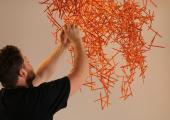 Thomas installing 'Pencils Work In Space' for a London branding agency