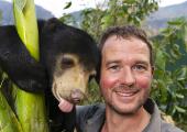 Giles Clark with Mary the sun bear at the Free the Bears sanctuary in Laos