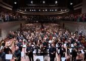 Paavo Järvi and players of the Estonian Festival Orchestra turn to greet the balcony audience, including members of the 100-plus Järvi Academy Youth Symphony Orchestra