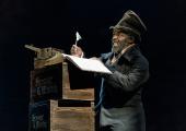 Paterson Joseph as Scrooge in his counting house before the ghostly adventures begin