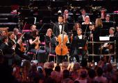 Mirga Gražinytė-Tyla and CBSO players congratulating Sheku Kanneh-Mason after his performance of Elgar's Cello Concerto