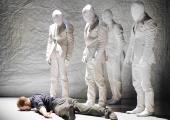 Wearing Nancy Bryant's eerily effective white masks, the conspirators contemplate Prospero (Eric Beauchesne).