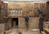 The first panels of the facsimile of Tutankhamun's tomb are installed by Adam Lowe (top right) and a team from Factum Arte