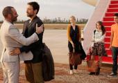 Jamal (Ashraf Barhom, left) greets Bassam (Adam Rayner) and family
