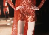 A masked lace dress by the late Alexander McQueen, from 1998, turns the catwalk into pure theatre 