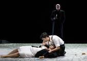 Rodolfo (Bekhzod Davronov) cradles Mimi (Gabriella Reyes) while Death (Peter Van Hulle) awaits