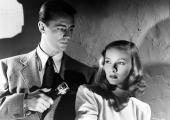 Defying the dark: Alan Ladd lights Veronica Lake in a 'Blue Dahlia' publicity still