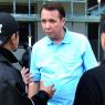 Mikhail Pletnev is questioned by a Thai police officer in front of the muscian's Pattaya residence