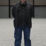 Ai Weiwei in his field of porcelain sunflower seeds. The seed, says the artist, symbolises the Chinese people