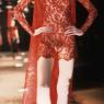 A masked lace dress by the late Alexander McQueen, from 1998, turns the catwalk into pure theatre 