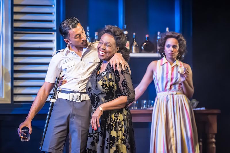 The policeman Seldom with his arm around Pearl, as Ruby looks annoyed in the background