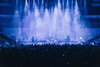 the stage of the Albert Hall with many blue spotlights shining down on it
