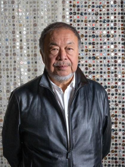 Ai Weiwei in front of an Eight-Nation flag