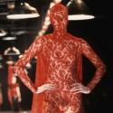 A masked lace dress by the late Alexander McQueen, from 1998, turns the catwalk into pure theatre 